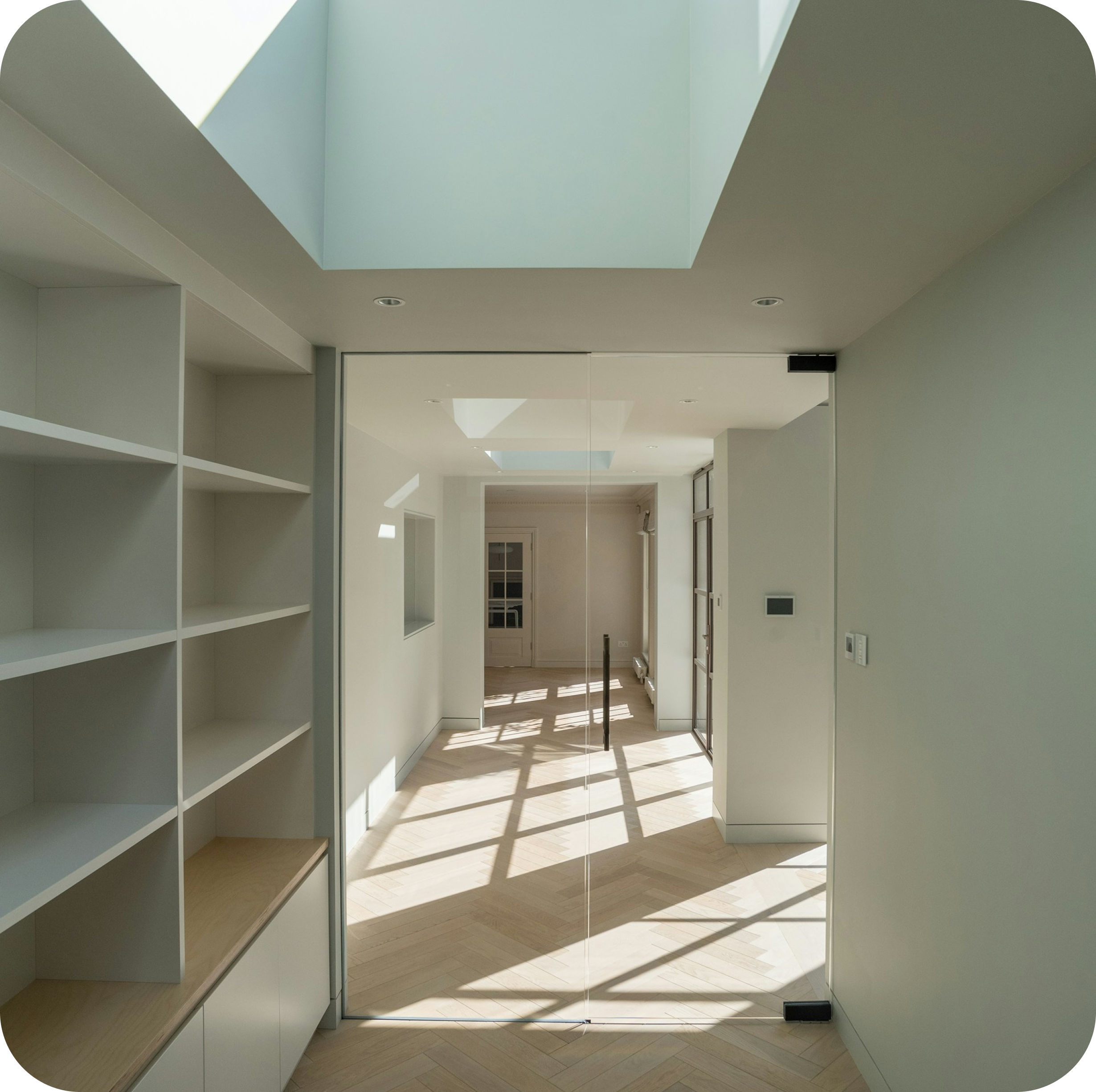 Minimalist hallway with skylight and dramatic shadows